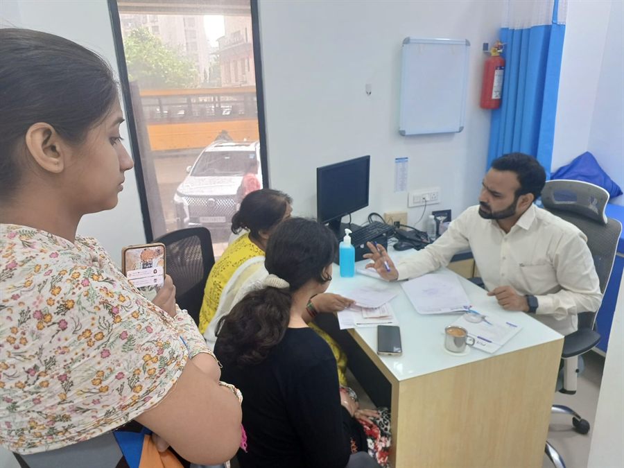 Staff registering visitors at a camp desk