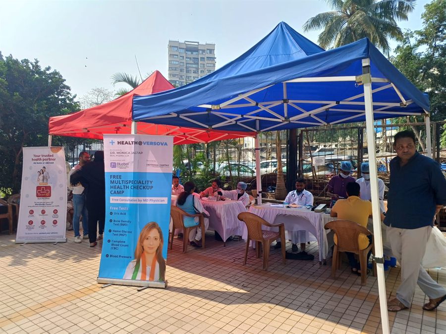 Visitors and staff at an outdoor health check-up camp