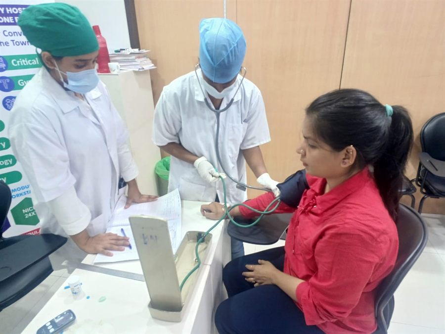 Staff members recording a visitor’s details at a check-up camp