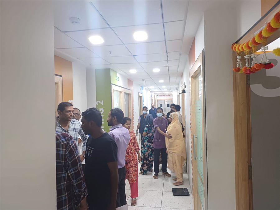 Visitors queuing in a hospital corridor during a camp