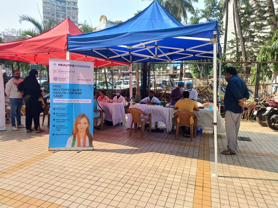 Consultation tables set up under gazebos at an outdoor camp