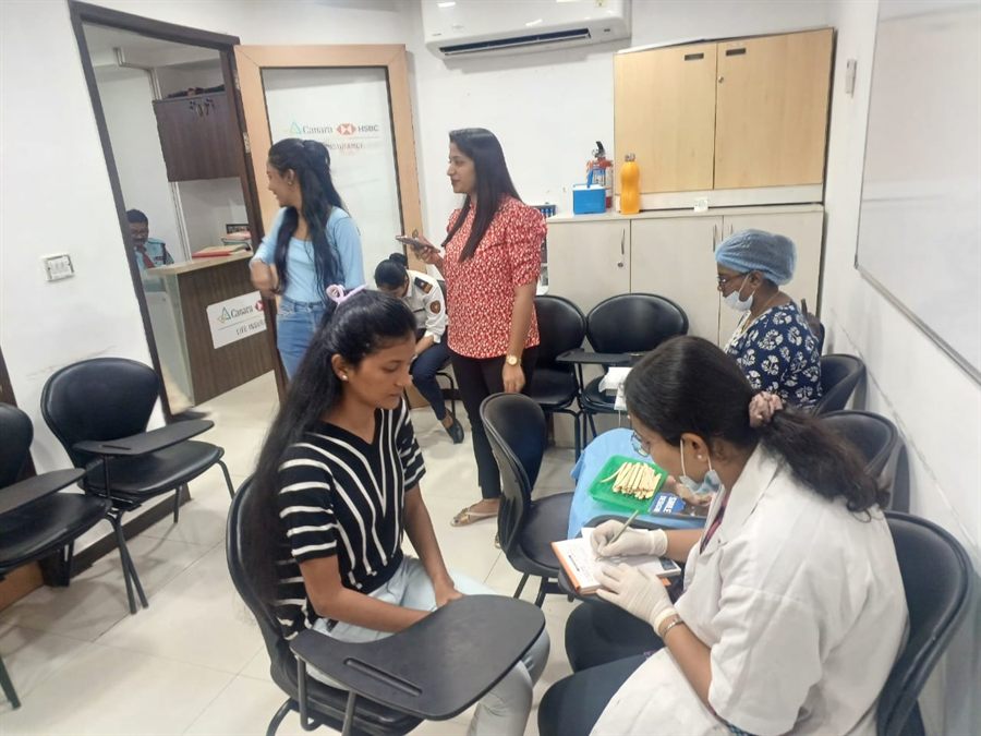 Visitors seated in a waiting area during a health check-up camp