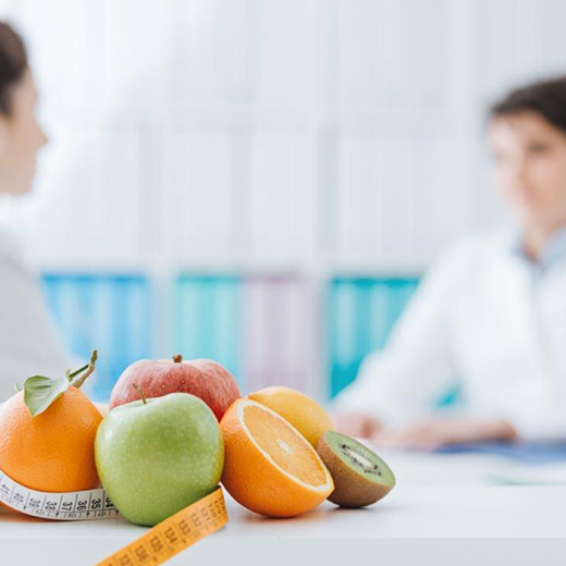 Fresh fruit and a measuring tape on a dietician’s desk